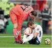  ?? CATHERINE IVILL ?? Harry Kane reacts in pain after twisting an ankle in a collision with Bournemout­h goalkeeper Asmir Begovic.