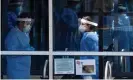  ?? Photograph: Olivier Douliery/AFP via Getty Images ?? Healthcare workers wait for patients to be tested at a walk-in Covid-19 testing site on 12 May in Arlington, Virginia.