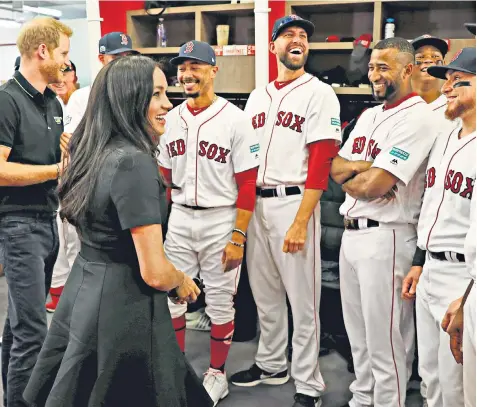  ??  ?? The Duke and Duchess of Sussex meet players of the Boston Red Sox baseball team before their match against the New York Yankees at the London Stadium last night