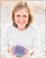  ?? DENISE BARKER/ MEGAN MURPHY VIA AP ?? This undated photo provided by Megan Murphy shows Murphy holding a painted rock at Sandy Neck Beach in Barnstable, Mass. The rock was part of The Kindness Rocks Project.