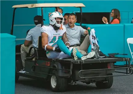  ?? JOHN MCCALL/SOUTH FLORIDA SUN SENTINEL ?? Dolphins cornerback Nik Needham is carted off the field against the Vikings at Hard Rock Stadium on Sunday.