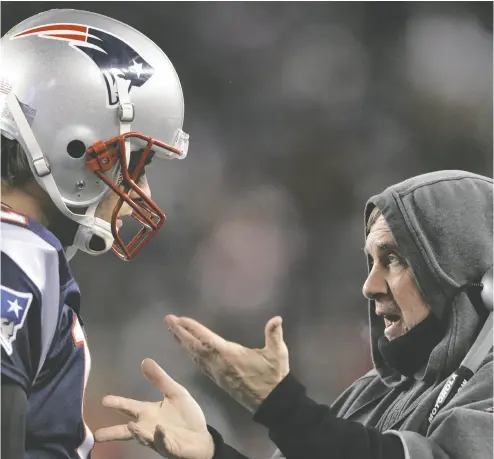  ?? ELSA / GETTY IMAGES ?? New England Patriots quarterbac­k Tom Brady talks with head coach Bill Belichick on the sideline during their AFC Divisional Playoff Game against the Denver Broncos in 2012. If Belichick ever realized that to coach football full time is an astonishin­g gift, he never gave the impression that he knew it, writes Raymond J. de Souza.