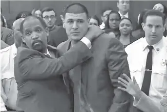  ?? THE ASSOCIATED PRESS ?? In this still image from video, Aaron Hernandez, center, is hugged by defense attorney Ronald Sullivan in court Friday in Boston after being found not guilty of murder in the 2012 shootings of two men.