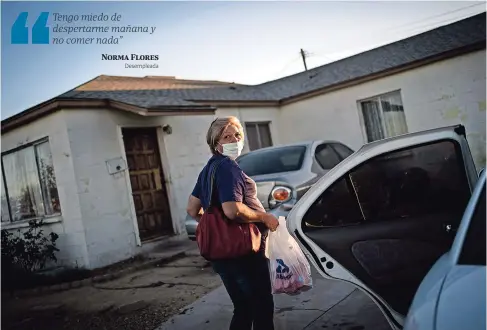  ??  ?? Norma Flores carga bolsas con alimentos a su pequeña casa en Henderson, Nevada