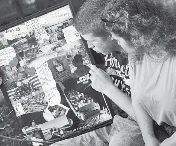  ?? William Colgin For The Times ?? DILLION CHANCEY and his mother, Sarah Fairchild, look over a collage of his young life, including photos of him after Katrina and the family’s trip to Disneyland, paid for by a Pasadena man who was moved to help.