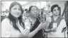  ??  ?? BJP leader &amp; party candidate Locket Chaterjee and other voters show voter identity cards at a polling booth in North 24 Pargana on Monday. PTI