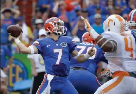  ?? AP PHOTOS ?? Florida quarterbac­k Will Grier (7) throws a pass as he is pressured by Tennessee defensive lineman LaTroy Lewis (4) during the first half of an NCAA college football game, Saturday, in Gainesvill­e.