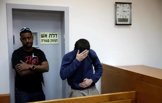  ??  ?? The teenager (right) attends a hearing in the Israeli city of Rishon LeZion yesterday (Reuters)