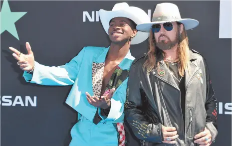  ?? AP PHOTO ?? Lil Nas X, left, and Billy Ray Cyrus arrive at the BET Awards on June 23 in Los Angeles.