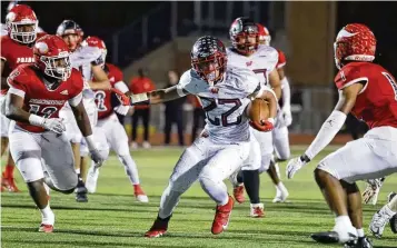  ?? NICK GRAHAM / STAFF ?? Lakota West’s Braydon Johnson carries the ball during their playoff football game against Princeton Friday at Mason.