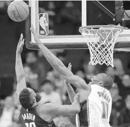  ?? ERIC CHRISTIAN SMITH/ASSOCIATED PRESS ?? Magic C Bismack Biyombo (11) defends a shot by Rockets G James Harden on Tuesday. Harden scored a franchise-record and career-high 60 points as part of a triple-double.