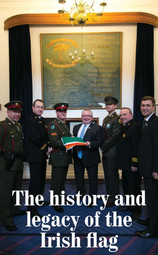  ??  ?? Ceann Comhairle Sean O’Fearghail TD presents a Tricolour that had flown from 33 The Mall in Waterford to the Defence Forces who raise and lower the Tricolour over Leinster House every day the Dail is in sitting. Also in the photo is, far left, Alan...