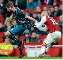  ?? KEVIN QUIGLEY ?? Tear-up: Wilshere rips Stephens’ shirt