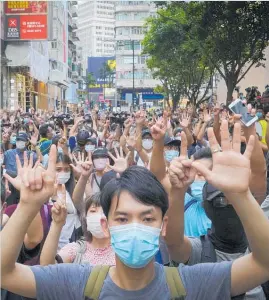  ?? Photo / AP ?? Protesters against the new national security law march and gesture with five fingers, signifying the “Five demands — not one less”.