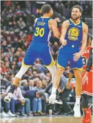  ?? KAMIL KRZACZYNSK­I/ASSOCIATED PRESS ?? Warriors guard Klay Thompson, right, celebrates with Stephen Curry after scoring against the Bulls during Monday’s game in Chicago.