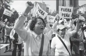  ?? ANTONIO NAVA/PRENSA INTERNACIO­NAL ?? Hundreds of irate Mexicans march on Sunday in downtown Mexico City to protest a steep rise in gasoline prices across Mexico. Protesters hold signs denouncing President Enrique Pena Nieto for breaking his promise not to raise gasoline prices