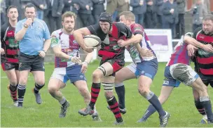  ?? Ian Moss ?? Try-scorer Mike Jones looks to break free of the New Brighton defence as Widnes go on the attack in last Saturday’s match.