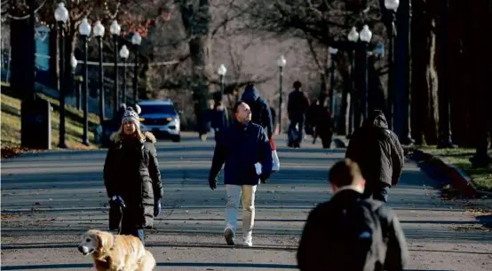  ?? LANE TURNER/GLOBE STAFF ?? Many MBTA riders are fed up with the shutdowns and slow zones. Rob Adams (center) cuts through the Boston Public Garden.