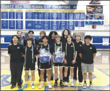  ?? ALAN HENDRY Valley Press ?? The Quartz Hill boys volleyball players and coaches pose for a photo after defeating Knight 20-25, 25-21, 25-18, 25-16 to win the Golden League title on Thursday at Quartz Hill High.