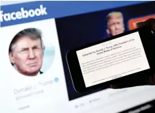  ?? — AFP file photo ?? In this photo illustrati­on, a phone screen displays the statement of Trump on his Facebook page background.