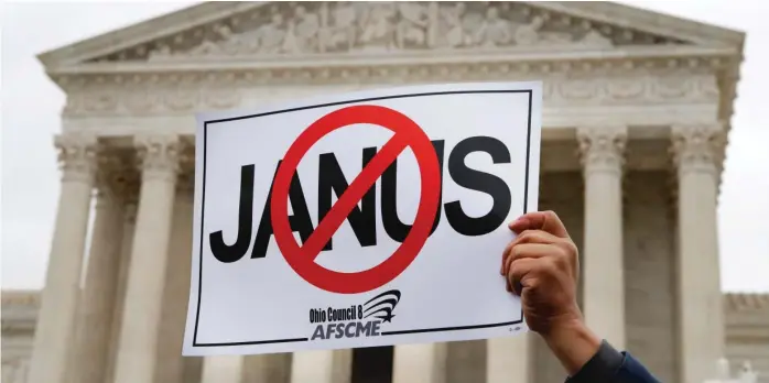  ?? JACQUELYN MARTIN/AP ?? A union member holds up a sign protesting the Janus v. AFSCME Council 31 case in February in Washington. The Supreme Court ruled on the case in June.