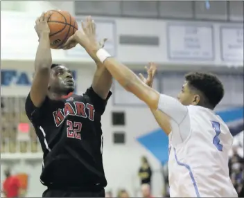  ?? Nikolas Samuels/The Signal ?? Hart’s Tre Harrill (22) goes for a shot as Saugus’ Adrian McIntyre guards him at Saugus on Friday.