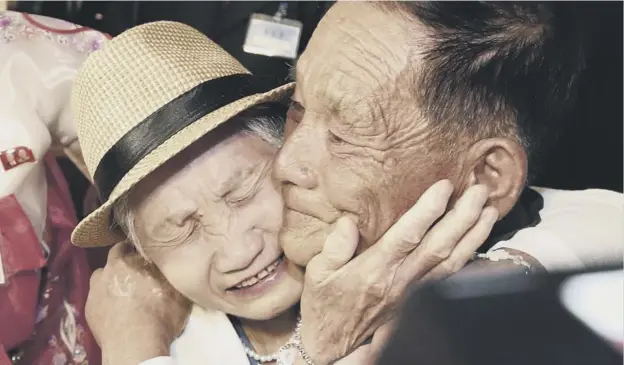  ??  ?? 0 South Korean Lee Keum-seom, 92, left, weeps as she is reunited with her North Korean son Ri Sang Chol, 71, at the Diamond Mountain resort in North Korea yesterday