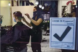  ?? KARL MONDON — BANG ARCHIVES ?? Cassandra Sanidad, co-owner of Bellarmine Salon in San Jose, gives a haircut on Dec. 3, just before the state’s regional stay-at-home order was enacted. Salons may now reopen with restrictio­ns with Monday’s lifting of the order.