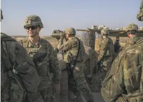  ?? Mauricio Lima / New York Times ?? Lt. Gen Paul Funk (left) speaks to a U.S. soldier outside Manbij city. The announceme­nt of a pullout is widely seen as an abandonmen­t of a loyal ally.