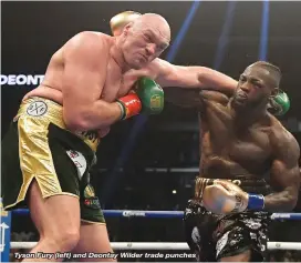  ??  ?? Tyson Fury (left) and Deontay Wilder trade punches