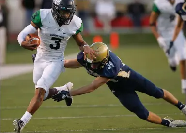  ?? (Arkansas Democrat-Gazette/Thomas Metthe) ?? Little Rock Christian quarterbac­k Justice Hill (3) shoves away Pulaski Academy safety Blake Titus during the Warriors’ 52-38 victory in the Class 5A state championsh­ip in 2018. The Arkansas Activities Associatio­n has put a proposal to a vote that would allow private schools such as Little Rock Christian and PA to move up or down in classifica­tion with the aim of creating more balanced competitio­n.