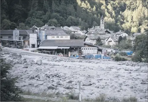  ??  ?? Bondo in Graubuende­n in South Switzerlan­d after mud and rockslides swept through the small Swiss village near the Italian border.