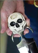  ??  ?? Barry included two pieces of his own jaw bone removed during dental surgery in the skullshape­d handle of the large push dagger he crafted.