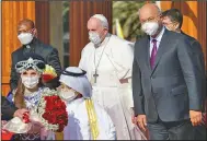  ?? (AP/Andrew Medichini) ?? Children accompany Pope Francis and Iraqi President Barham Salih as they meet Friday at the Presidenti­al Palace in Baghdad.