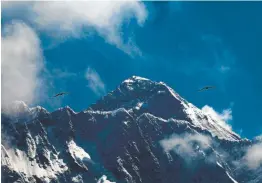  ?? Niranjan Shrestha, Associated Press ?? Left: Birds fly as Mount Everest is seen from Namche Bajar, Solukhumbu district, Nepal on May 27.