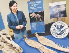  ??  ?? RETURN HOME: Tsedevdamb­a poses with part of a 70 million-year-old, nearly complete Tyrannosau­rus Bataar skeleton in New York. — AFP photo