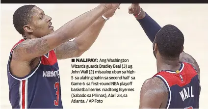  ?? AP Foto ?? ■ NALIPAY: Ang Washington Wizards guards Bradley Beal (3) ug John Wall (2) misaulog uban sa high5 sa ulahing bahin sa second half sa Game 6 sa first-round NBA playoff basketball series niadtong Biyernes (Sabado sa PIliinas), Abril 28, sa Atlanta. /