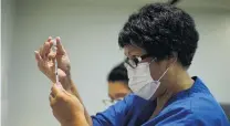  ?? PHOTO: SUPPLIED/MINISTRY OF HEALTH ?? Ready . . . A vaccinator prepares one of New Zealand's first Covid19 vaccinatio­ns yesterday in Auckland.