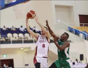  ??  ?? Qatar’s Nedim Muslic goes for the basket during the FIBA Asia Cup 2021 Qualifiers against Saudi Arabia at the Al Gharafa Sports Club on Monday. Qatar went down 73-67 in Overtime after the scores were locked 67-all.