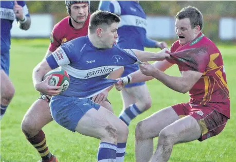  ??  ?? Caernarfon and Dolgellau players get to grips with each other