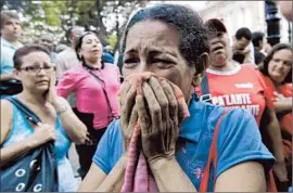  ?? Ariana Cubillos
Associated Press ?? CHAVEZ SUPPORTERS after learning that he had died. Venezuela’s new leaders probably won’t abandon socialism, but they’re expected to be less polarizing.
