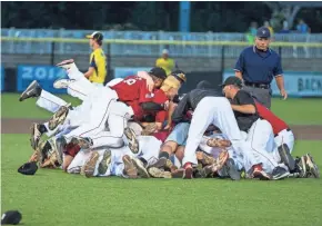  ?? TYGER WILLIAMS / MILWAUKEE JOURNAL SENTINEL ?? The Muskego baseball team celebrates after its victory over Pius XI in the last summer title game.