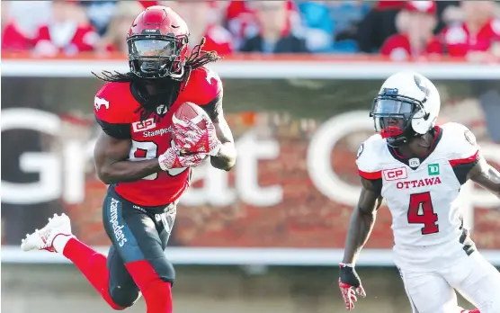  ?? AL CHAREST ?? Marken Michel of the Stampeders hauls in a 26-yard scoring toss during the second quarter of Calgary’s 43-39 victory over the visiting Redblacks at McMahon Stadium.