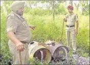  ?? GURPREET SINGH/HT ?? Police with stills used for distilling illicit liquor on the Sutlej banks in Ludhiana district on Tuesday.