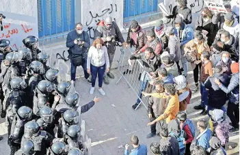  ?? — AFP photo ?? Tunisian police block protesters from accessing the parliament building in Tunis.
