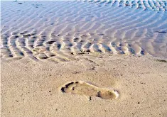  ??  ?? Leaving a mark: a footprint on the sand at St Ives, a popular Cornish tourist destinatio­n