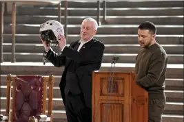  ?? STEFAN ROUSSEAU — POOL PHOTO VIA AP ?? Speaker of the House of Commons Sir Lindsay Hoyle, left, holds the helmet of one of the most successful Ukrainian pilots, inscribed with the words “We have freedom; give us wings to protect it,” which was presented to him by Ukrainian President Volodymyr Zelenskyy as he addressed parliament­arians in Westminste­r Hall, London,, on Wednesday.