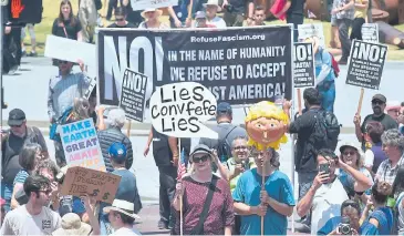  ?? AFP ?? Activists carrying placards with political points of view march to City Hall through downtown Los Angeles, California, on Saturday, in the March For Truth.