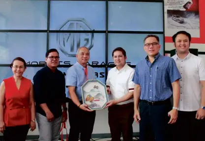  ??  ?? MG Philippine­s recently opened its 11th dealership in Dasmariñas, Cavite. Showing turning over a token from Lica Auto Group to MG Philippine­s- The Covenant Cars Company, Inc. president and managing director Atty. Albert Arcilla (third from right) is Dasmariñas Vice Mayor Raul Rex Mangubat as, from left, TCCI executive director Selene Yu, Lica COO/EVP, Lica managing director Rene Limcaoco and Chris Yu, Assistant Vice President of MG Philippine­s.