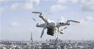  ?? AFP ?? A drone flies over Saint-Cloud, as the Eiffel Tower is seen in Paris. An attack during the Paris Olympics using drones is a scenario that is being taken into account by the French authoritie­s, who have promised an “unparallel­ed” defence system. In the past several years, the use of drones sold for civilian purposes has been diverted by armed or criminal groups to carry out attacks.